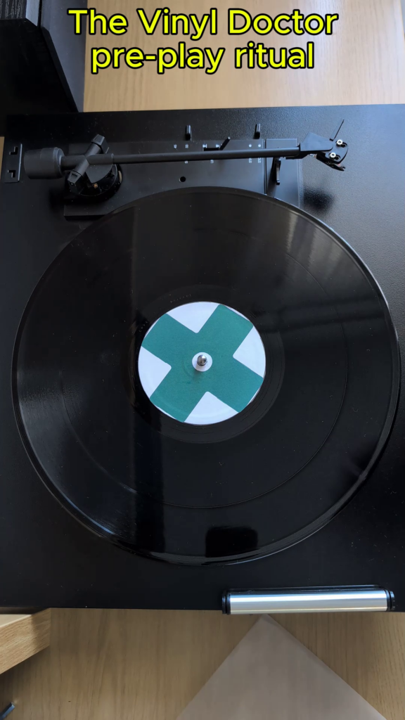 Vinyl record on turntable platter with rotation engaged.