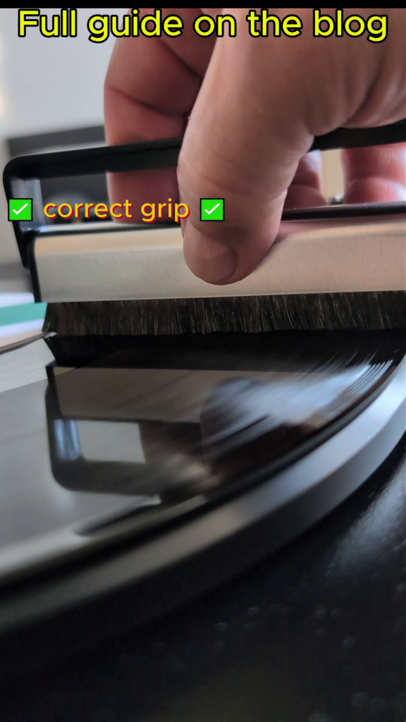 Holding a carbon fibre record brush by the metal casing.