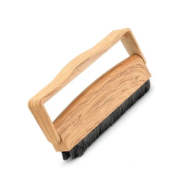Unsuitable handheld brush for vinyl records with non-carbon bristles and rigid handle design.